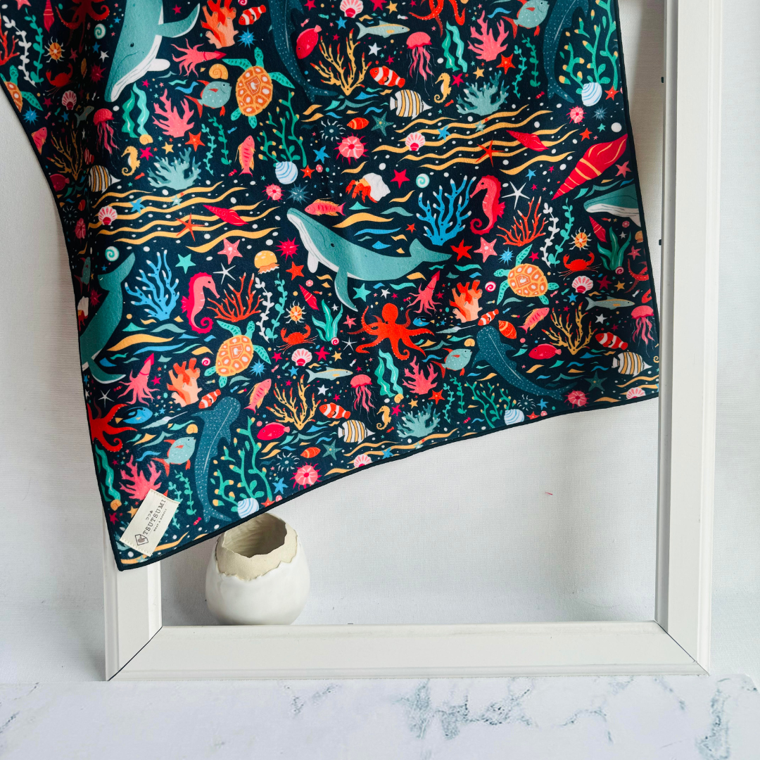 Clingy Wrap showing marine scene with fishes, whales, seahorses, turtles, and whale sharks amidst corals and seaweeds.