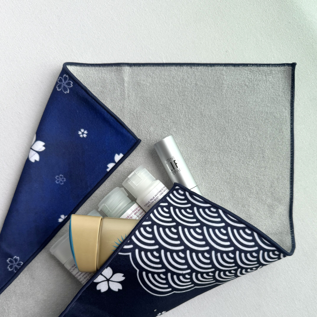 Blue patterned fabric wrap with white sakura and seigaiha (wave) pattern holding skincare products