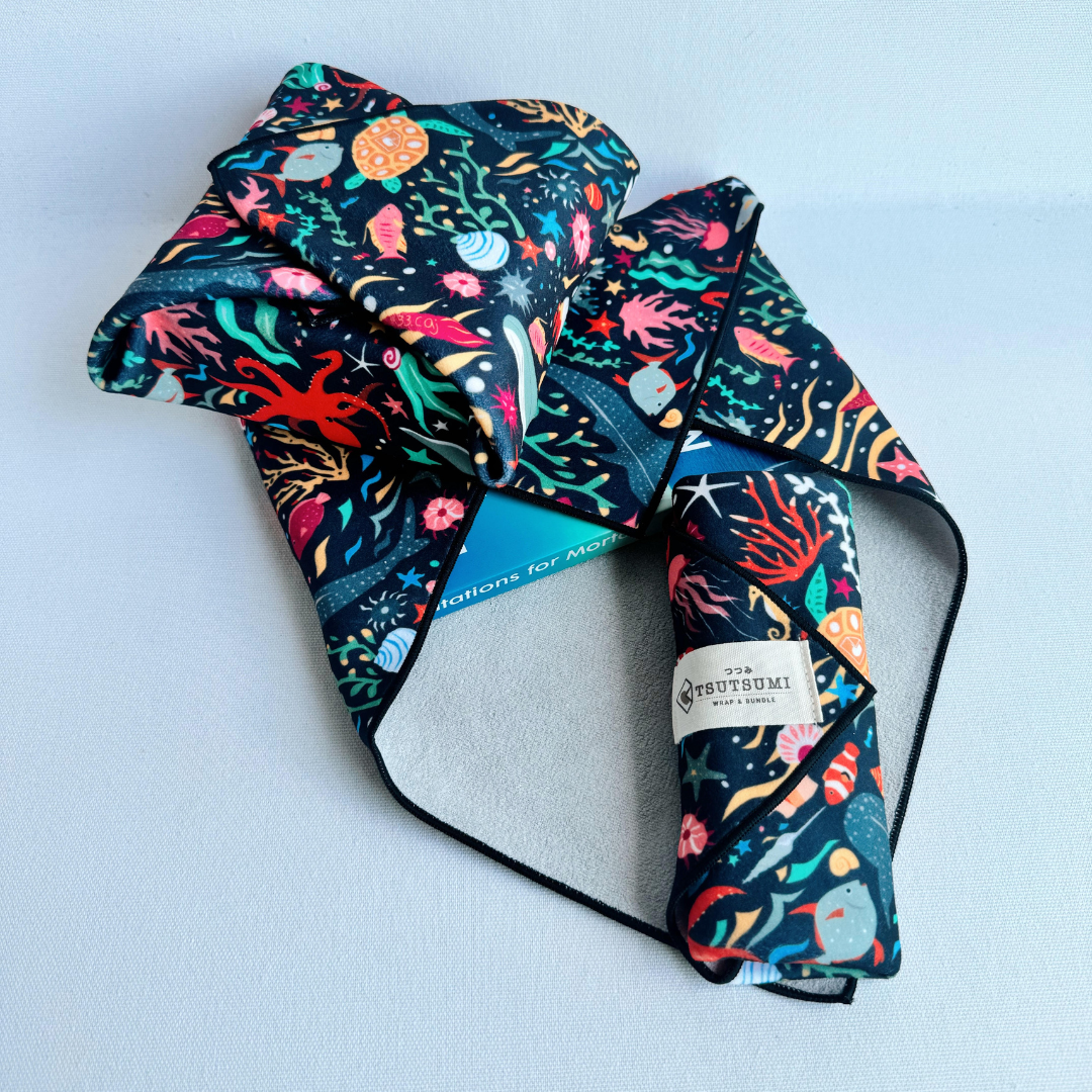 3 pieces of fabric with Marine Fantasy print in dark blue background each wrapping different items.