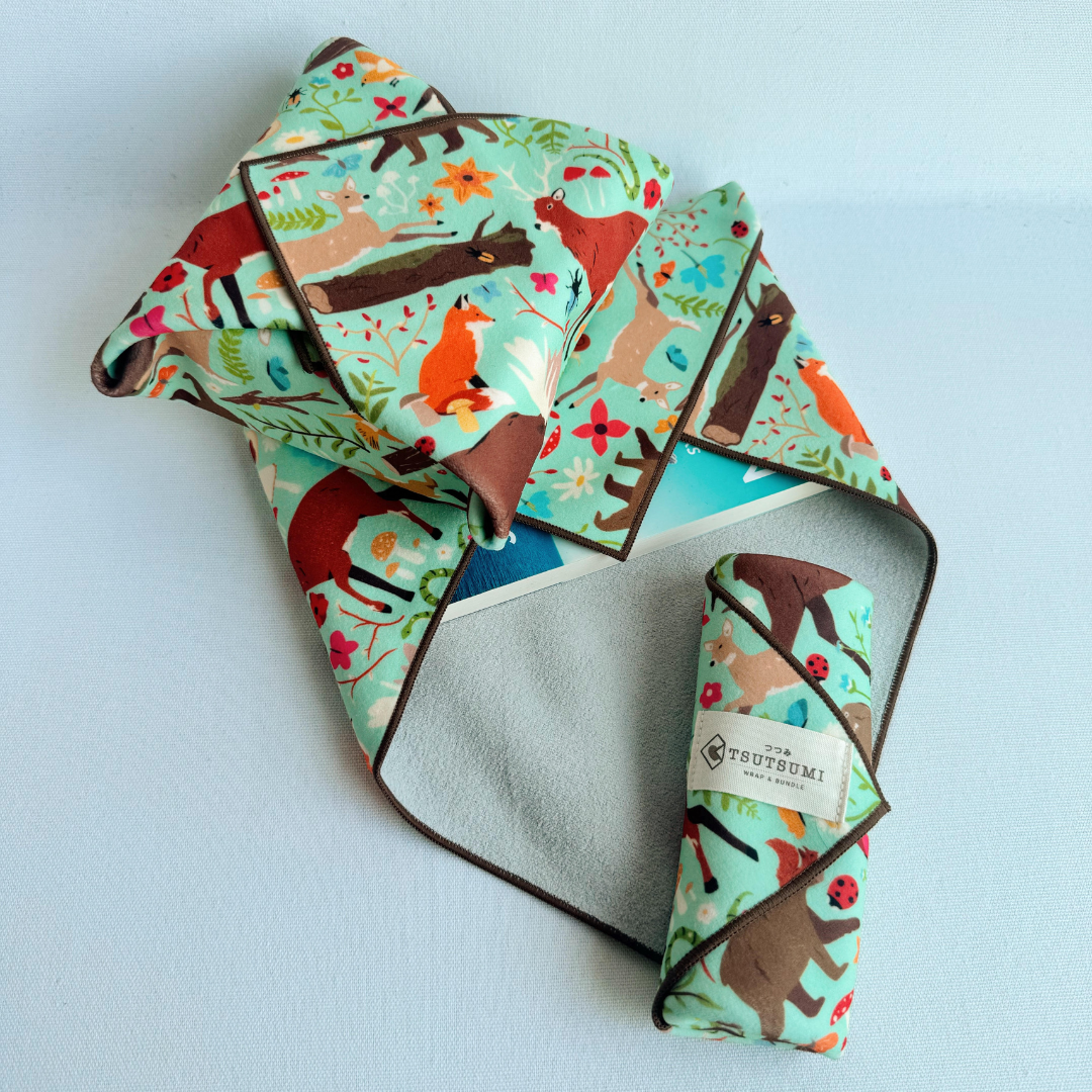 3 pieces of fabric with Woodland Fantasy print in mint green background each wrapping different items.