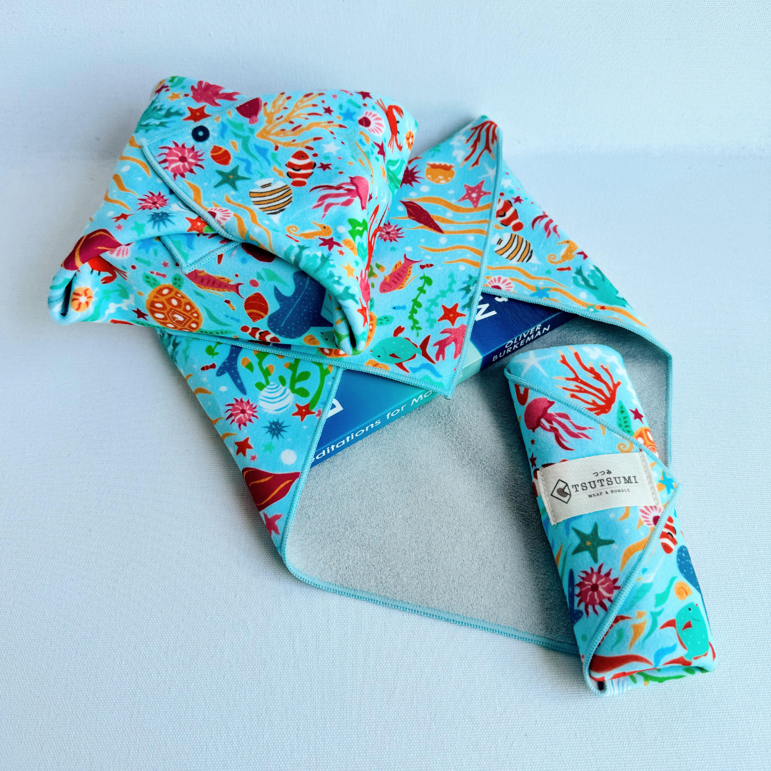 3 pieces of fabric with Marine Fantasy print in light blue background each wrapping different items.