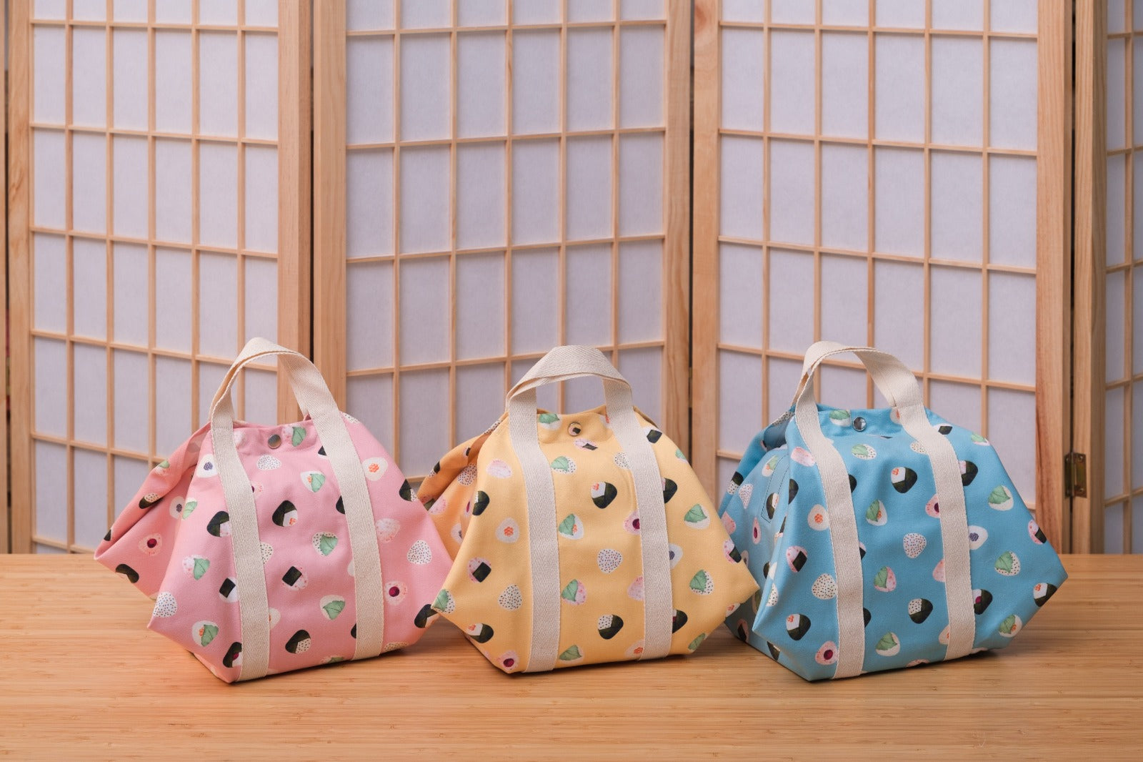 Tsutsumi Square Wraps in Onigiri design. In pink, yellow and blue.