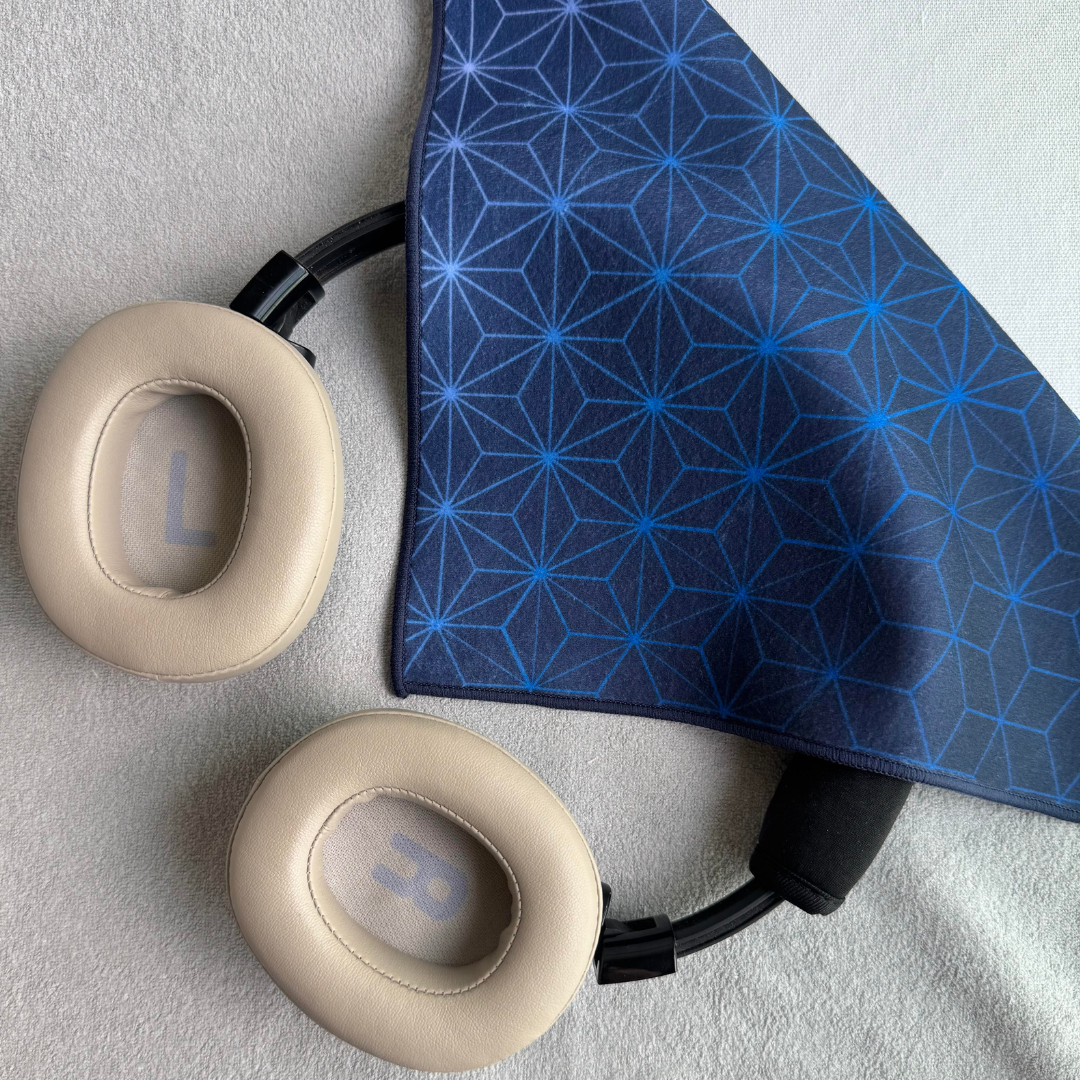 Blue Asanoha geometric patterned fabric partially wrapping earphones
