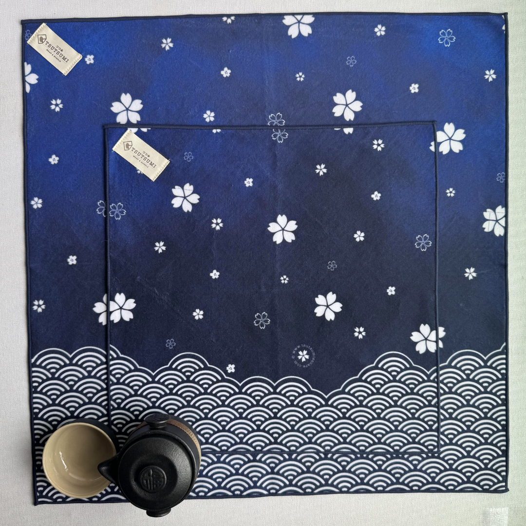 Blue fabric wraps with white sakura and seigaiha (wave) pattern of 2 different sizes on a white background