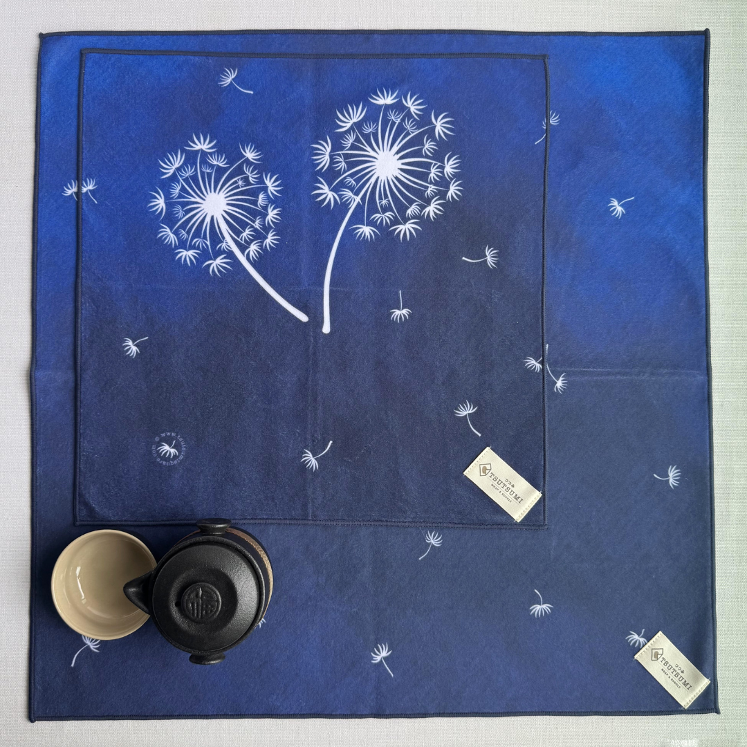 Blue patterned fabric wraps with dandelion pattern of 2 different sizes on a white background