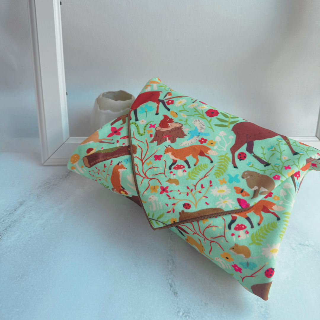 Tsutsumi Clingy Wrap with woodland creatures artwork on mint green background, fully wrapping a box.