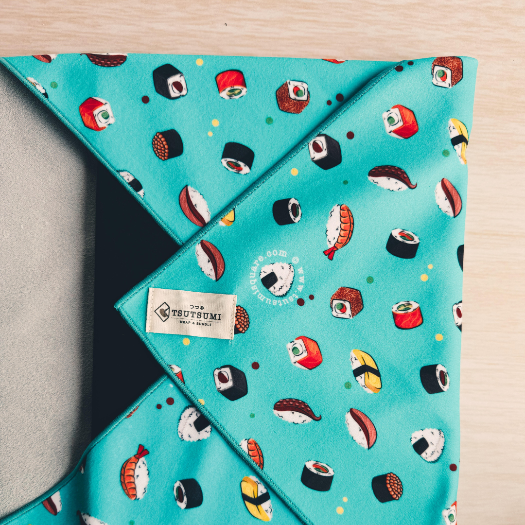 Blue fabric with sushi pattern wrapping a laptop