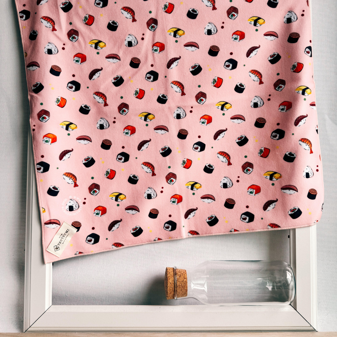 Pink fabric with sushi pattern draping over a picture frame