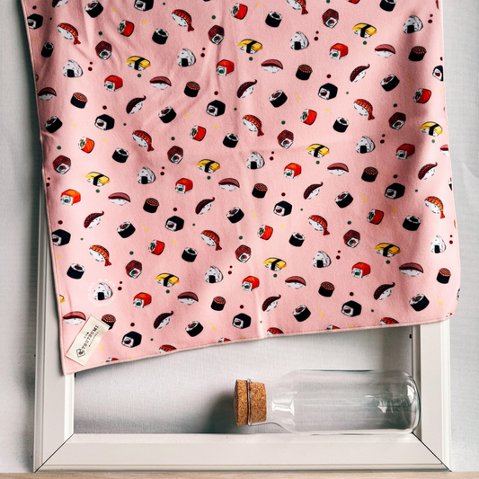 Pink fabric with sushi pattern draping over a picture frame