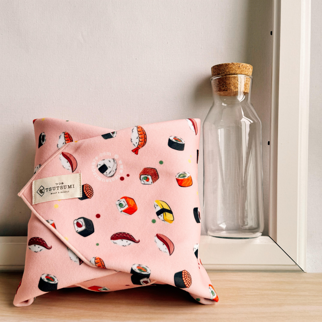 Pink fabric with sushi pattern wrapping some books
