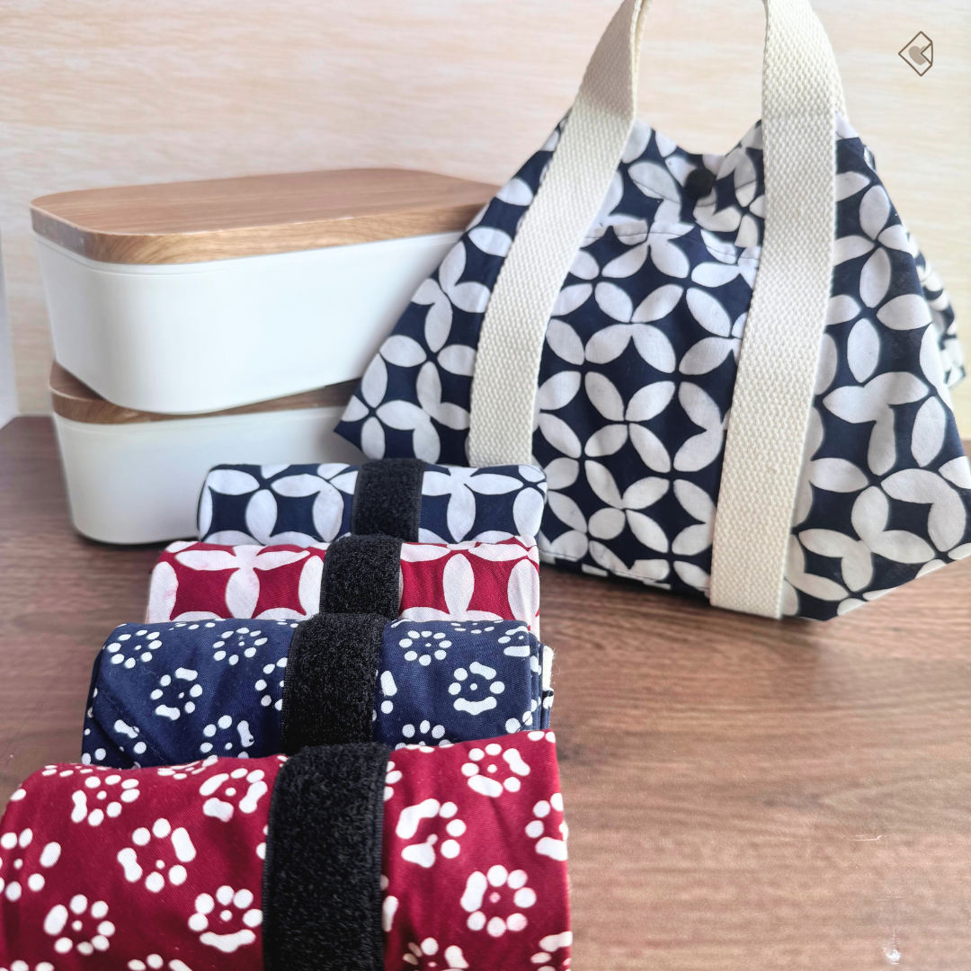 Set of patterned bags on a wooden surface with a wooden container in the background.