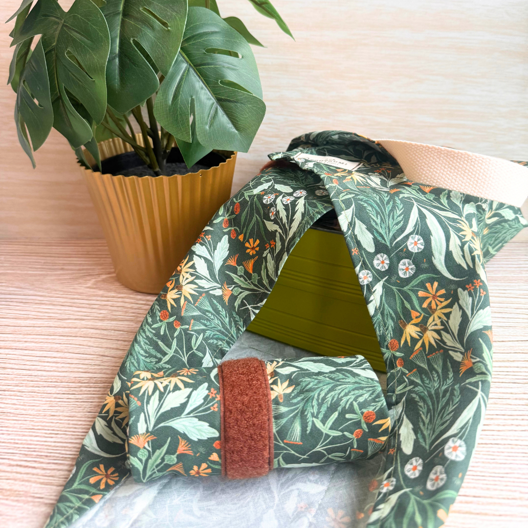 Green floral-patterned fabric square wrap next to small plant