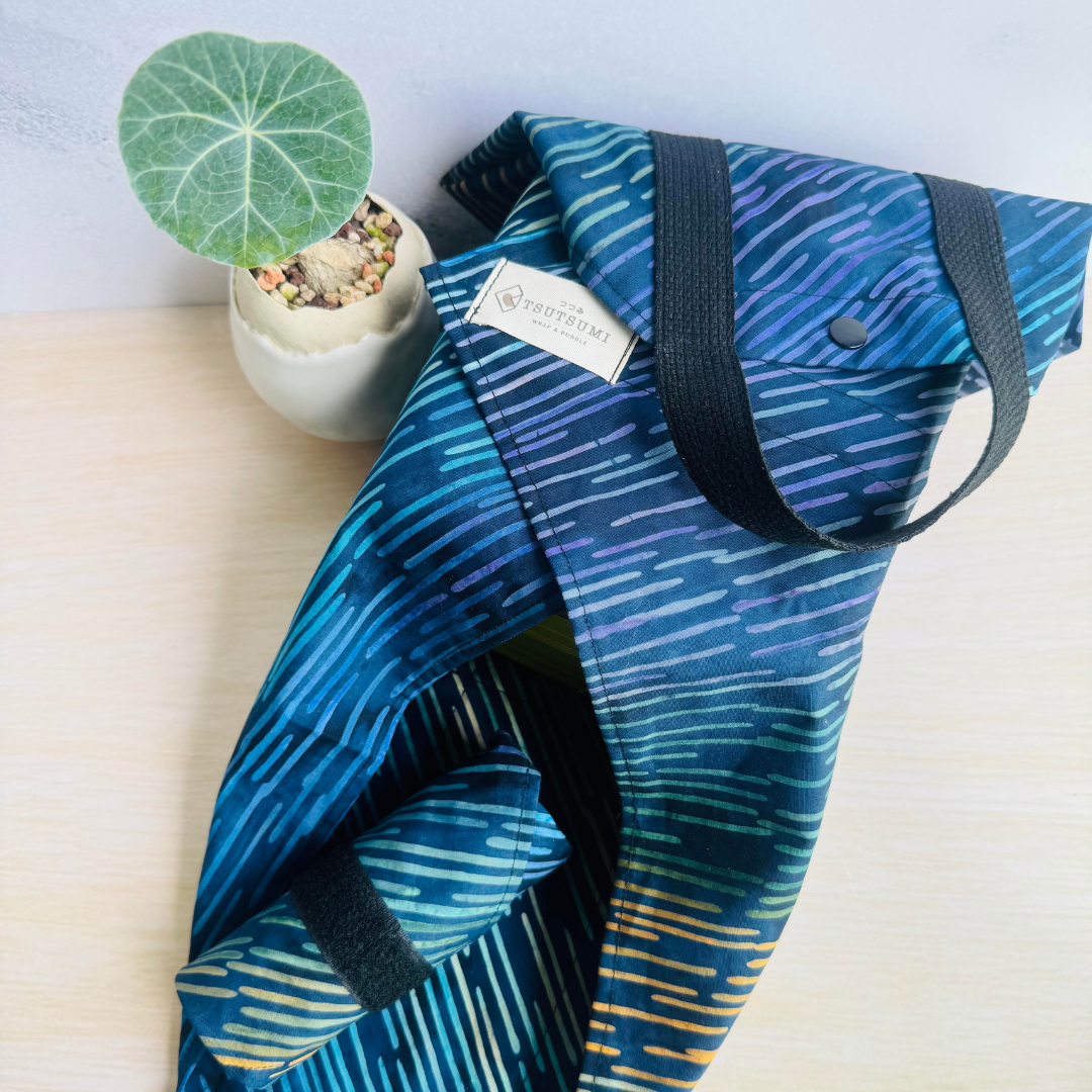 Half-opened Navy fabric Square Wrap and a rolled up Navy fabric Square Wrap