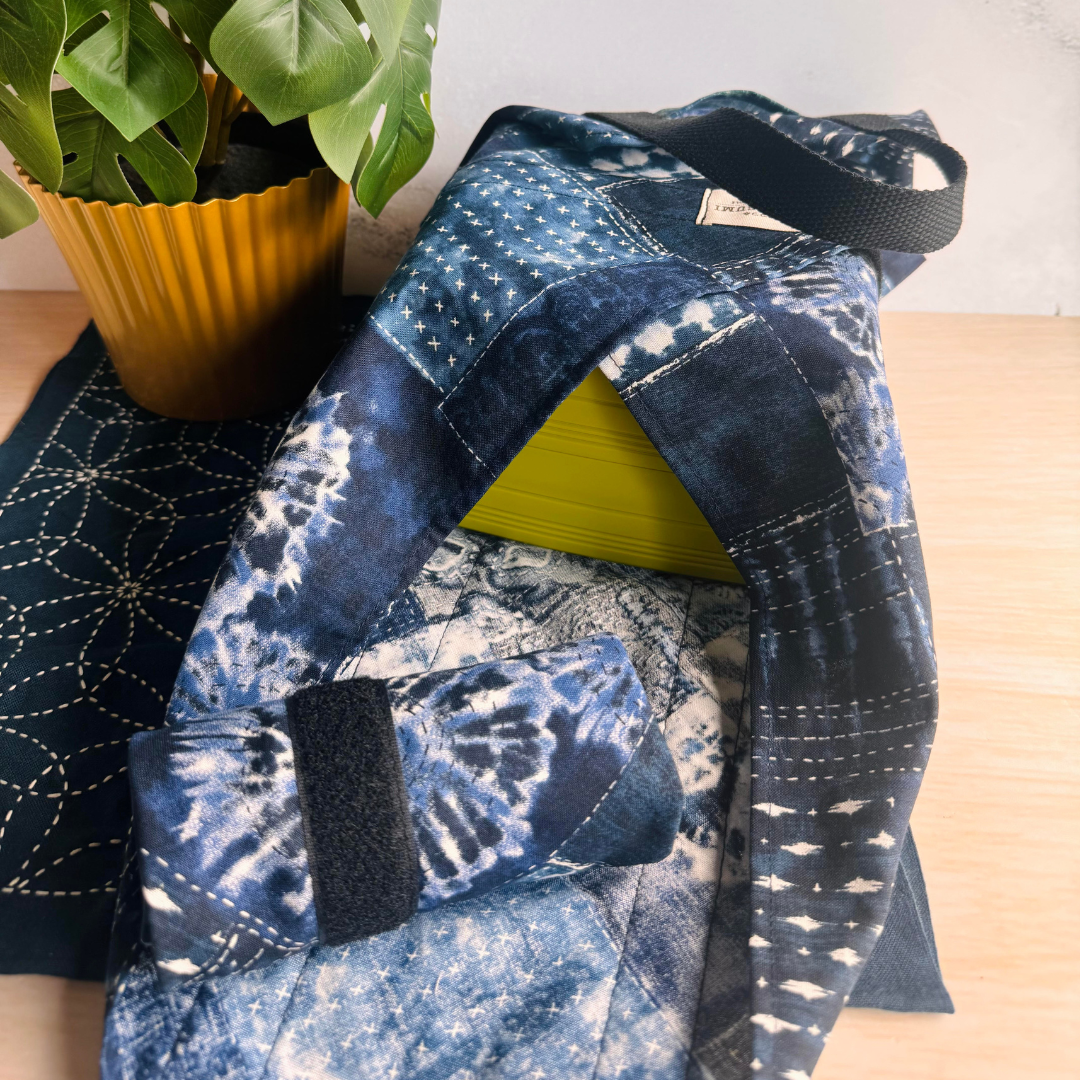 Blue Sashiko Patchwork patterned fabric wrap with a lime green box on a wooden surface