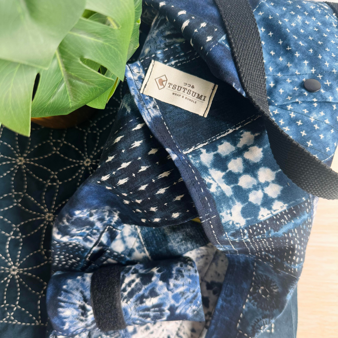 Blue Sashiko Patchwork patterned fabric wrap with a visible brand label on a textured surface.